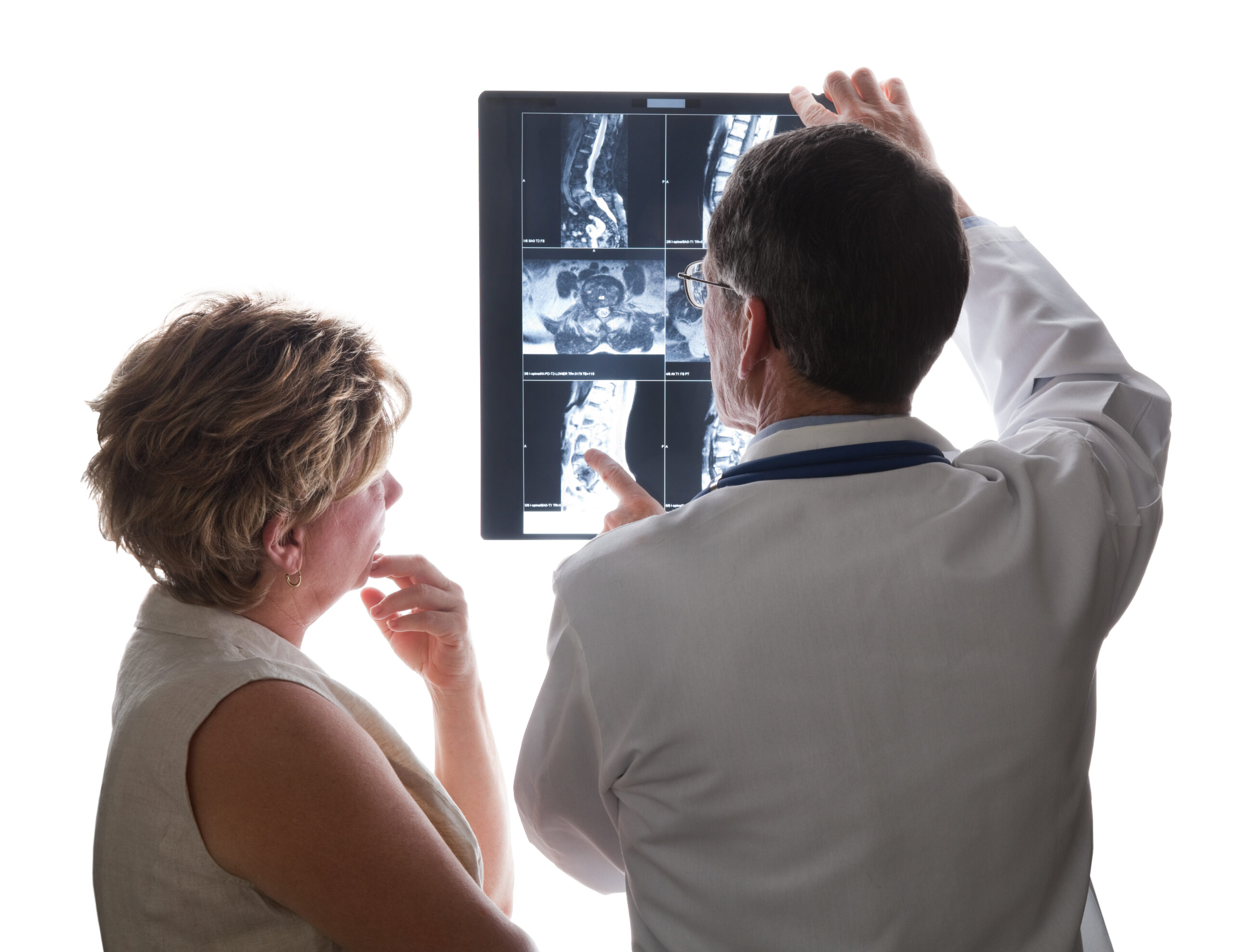 A male spinal surgeon discussing innovative cervical disc fusion techniques with a female patient.